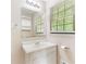 Bathroom featuring a white vanity, mirror, and window with blinds at 2585 Whisper Trail, Douglasville, GA 30135