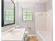 Bathroom featuring a large mirror, window for natural light, tub with shower, and modern sink at 2585 Whisper Trail, Douglasville, GA 30135