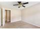 Neutral carpeted bedroom offers a ceiling fan, light walls, and an open doorway at 2585 Whisper Trail, Douglasville, GA 30135