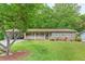 Lovely single-story brick home featuring a covered carport, a welcoming front porch, and a well-maintained front lawn at 2585 Whisper Trail, Douglasville, GA 30135