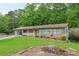 Charming brick home with a quaint front porch and well-manicured lawn surrounded by lush greenery at 2585 Whisper Trail, Douglasville, GA 30135