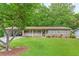 Charming single-story brick home featuring a covered porch and well-maintained front yard at 2585 Whisper Trail, Douglasville, GA 30135