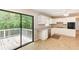 This kitchen is equipped with stainless appliances, white cabinetry, and a sliding glass door to the deck at 2585 Whisper Trail, Douglasville, GA 30135