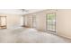 Bright living room with neutral walls, plush carpeting, and plenty of natural light from the windows at 2585 Whisper Trail, Douglasville, GA 30135