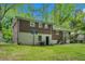 This expansive backyard boasts a lush green lawn and a charming deck, complemented by a classic brick home at 2623 Riggs Dr, Atlanta, GA 30344