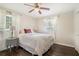 Bedroom featuring a ceiling fan, hardwood floors, a closet, and two windows at 2623 Riggs Dr, Atlanta, GA 30344
