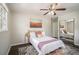 Bedroom featuring a ceiling fan, hardwood floors, a closet, and a large window at 2623 Riggs Dr, Atlanta, GA 30344