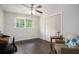 Bedroom featuring a ceiling fan, hardwood floors, a closet, a window, and a sofa at 2623 Riggs Dr, Atlanta, GA 30344