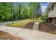 Landscaped front yard with mature trees, a driveway, and a welcoming entrance to the home at 2623 Riggs Dr, Atlanta, GA 30344