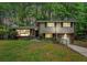 Charming two-story home featuring a well-manicured lawn, a garage, and a welcoming front porch at 2623 Riggs Dr, Atlanta, GA 30344