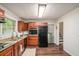 The kitchen features wood cabinets, stainless steel appliances, granite counters, and hardwood floors at 2623 Riggs Dr, Atlanta, GA 30344