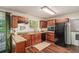 Functional kitchen with granite countertops, dark wood cabinetry, and black appliances at 2623 Riggs Dr, Atlanta, GA 30344