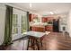 View of the kitchen featuring wood cabinets, stainless steel appliances, hardwood floors, and access to outdoor patio at 2623 Riggs Dr, Atlanta, GA 30344