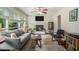 Bright and cozy living room with a fireplace, comfortable seating, and natural light from the windows at 2623 Riggs Dr, Atlanta, GA 30344