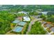 Aerial view of community featuring tennis courts, pool, lake, clubhouse, and lush greenery at 316 Denali Butte Ter, Canton, GA 30114