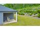 Inviting covered patio in backyard that features well-maintained lawn and manicured landscaping at 316 Denali Butte Ter, Canton, GA 30114