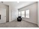 Bedroom showcasing a comfortable black armchair and double closets, illuminated by natural light at 316 Denali Butte Ter, Canton, GA 30114