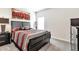 Comfortable bedroom showcasing a bed with decorative pillows, a nightstand, and a large dresser at 316 Denali Butte Ter, Canton, GA 30114