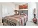 Bedroom features a large bed, stylish artwork, and a decorative floor vase by a window at 316 Denali Butte Ter, Canton, GA 30114