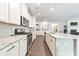 Bright kitchen features stainless steel appliances and white cabinets and stone countertops at 316 Denali Butte Ter, Canton, GA 30114