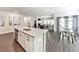 Bright kitchen area with a large granite island, open to the dining and living areas at 316 Denali Butte Ter, Canton, GA 30114