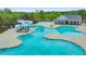 Community pool featuring a water slide and spacious lounging areas on a sunny day at 316 Denali Butte Ter, Canton, GA 30114