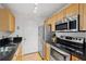 Kitchen featuring stainless appliances, granite countertops and wood cabinets at 1075 Peachtree Ne Walk # A204, Atlanta, GA 30309