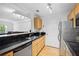 Kitchen featuring stainless appliances, granite countertops and wood cabinets at 1075 Peachtree Ne Walk # A204, Atlanta, GA 30309