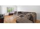 Bright living room area with hardwood floors and a large sectional sofa at 1075 Peachtree Ne Walk # A204, Atlanta, GA 30309