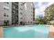 Beautiful outdoor pool with city views and patio seating area for relaxation at 1075 Peachtree Ne Walk # A204, Atlanta, GA 30309
