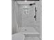Modern bathroom shower with window and sleek black fixtures and marble style tiles at 1766 Blossom Ln, Austell, GA 30168