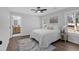 Serene bedroom with a ceiling fan, bright windows, and an en-suite bathroom, creating a relaxing retreat at 1766 Blossom Ln, Austell, GA 30168