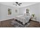Well lit bedroom with hardwood floors, ceiling fan and bright windows at 1766 Blossom Ln, Austell, GA 30168