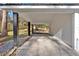 Covered carport with concrete flooring and black support beams at 1766 Blossom Ln, Austell, GA 30168