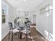 Bright dining area with a glass table and modern chairs, seamlessly connected to a stylish kitchen at 1766 Blossom Ln, Austell, GA 30168
