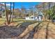 Expansive front yard showcasing a charming one-story home with white siding and mature trees at 1766 Blossom Ln, Austell, GA 30168