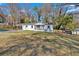 Cozy home with a carport and front porch nestled on a spacious lot with mature trees at 1766 Blossom Ln, Austell, GA 30168