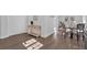 Hallway featuring hardwood floors, a decorative table, and access to the dining room, enhancing the home's appeal at 1766 Blossom Ln, Austell, GA 30168
