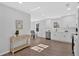 Bright kitchen showcasing white cabinets, stainless steel appliances, modern fixtures, and open layout to dining area at 1766 Blossom Ln, Austell, GA 30168