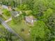 Aerial shot of an expansive home with lush landscaping, surrounded by mature trees, highlighting its privacy and curb appeal at 1822 Morgan Rd, Canton, GA 30115