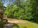 Spacious backyard with stairs from deck, offering a natural retreat and outdoor possibilities at 1822 Morgan Rd, Canton, GA 30115