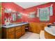 This bathroom has a tub, tile floors, and wood paneling underneath the red paint on the walls at 1822 Morgan Rd, Canton, GA 30115