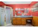 This bathroom has a frosted shower, tile floors, and wood paneling underneath the red paint on the walls at 1822 Morgan Rd, Canton, GA 30115