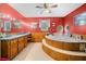 This bathroom has a tub, tile floors, and wood paneling underneath the red paint on the walls at 1822 Morgan Rd, Canton, GA 30115