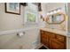 Bright bathroom featuring wood cabinets, a sink, and wainscoting at 1822 Morgan Rd, Canton, GA 30115
