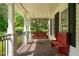 Charming front porch with a swing and bench offering a cozy and inviting outdoor space to enjoy the neighborhood at 1822 Morgan Rd, Canton, GA 30115