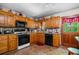 Traditional kitchen with wood cabinets, tile floors, and granite countertops at 1822 Morgan Rd, Canton, GA 30115