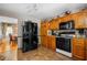 Spacious kitchen with wooden cabinets, black appliances, and tiled flooring at 1822 Morgan Rd, Canton, GA 30115