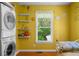 Bright laundry room with washer and dryer, open shelving, and a window providing natural light at 1822 Morgan Rd, Canton, GA 30115