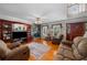 A spacious living room with hardwood floors, a stone fireplace, and a cozy seating arrangement perfect for relaxation at 1822 Morgan Rd, Canton, GA 30115